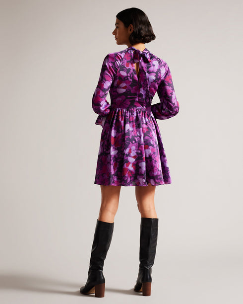 SAMMIEH-Dresses-Hello, gorgeous. SAMMIEH is the ultimate in flirty flower power. Featuring frills, cut outs and a vibrant floral print, this mini dress is just as at home with chunky boots as it is with sky high heels.The fabric of this product is made of 100% recycled polyester. Using recycled polyester helps divert plastic waste from ending in landfills and helps us to reduce our dependancy on virgin materials. Mini dress Floral print Fit and flare Long sleeved with frill cuffs High neck Zip fastening Tie
